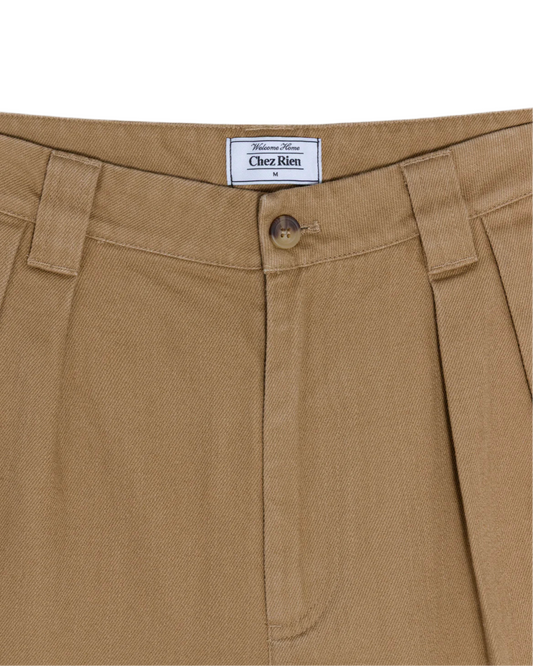 Close-up of shorts with a ‘Chez Rien’ label on a white background