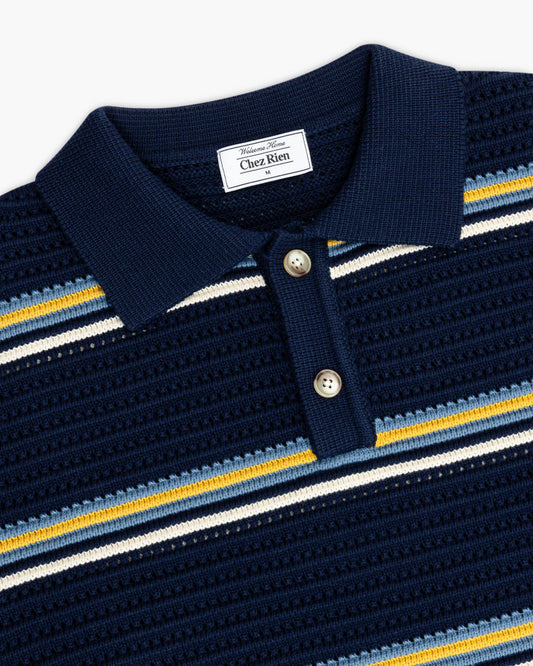 Navy striped knit polo shirt with 'Chez Rien' label on a white background