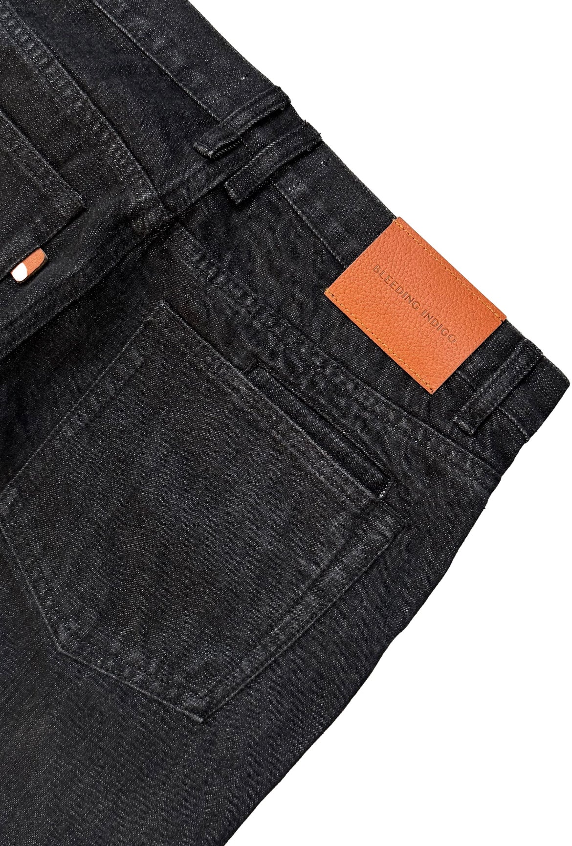 Closeup of the tag on the back of Black Cornell Jeans on a white background