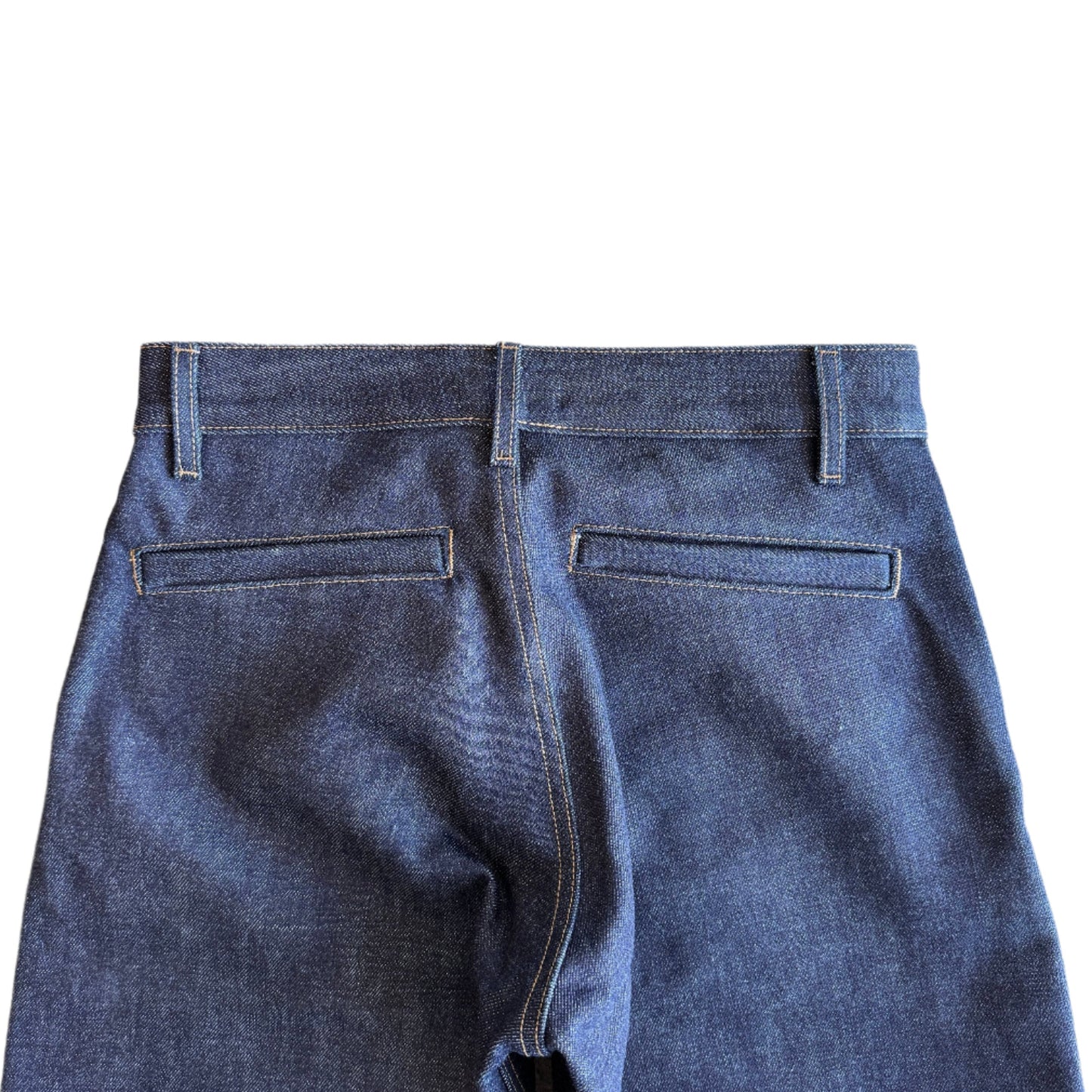 The Hidden Rivet Grounded Hemp Selvedge Denim on a pebbled brown background