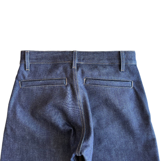 The Hidden Rivet Grounded Hemp Selvedge Denim on a pebbled brown background