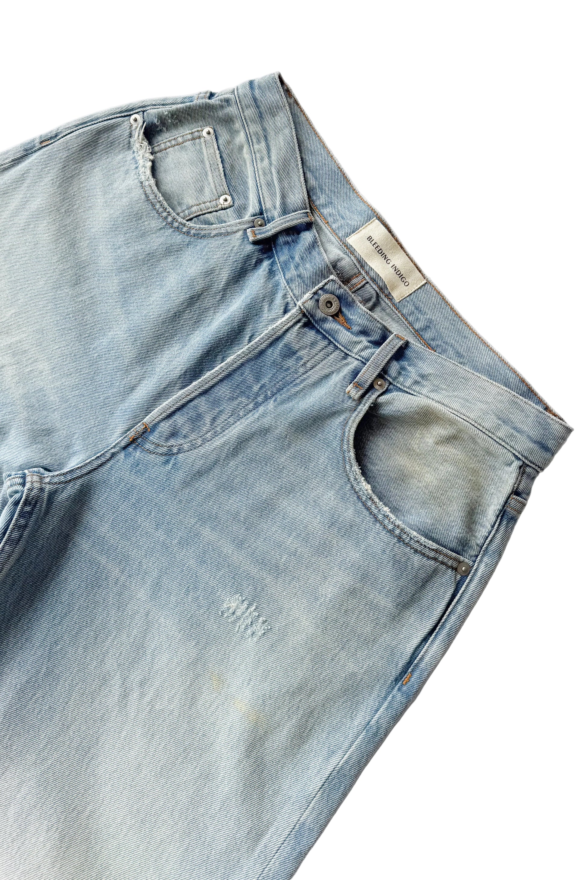 Light blue denim jeans with a brand label on a white background