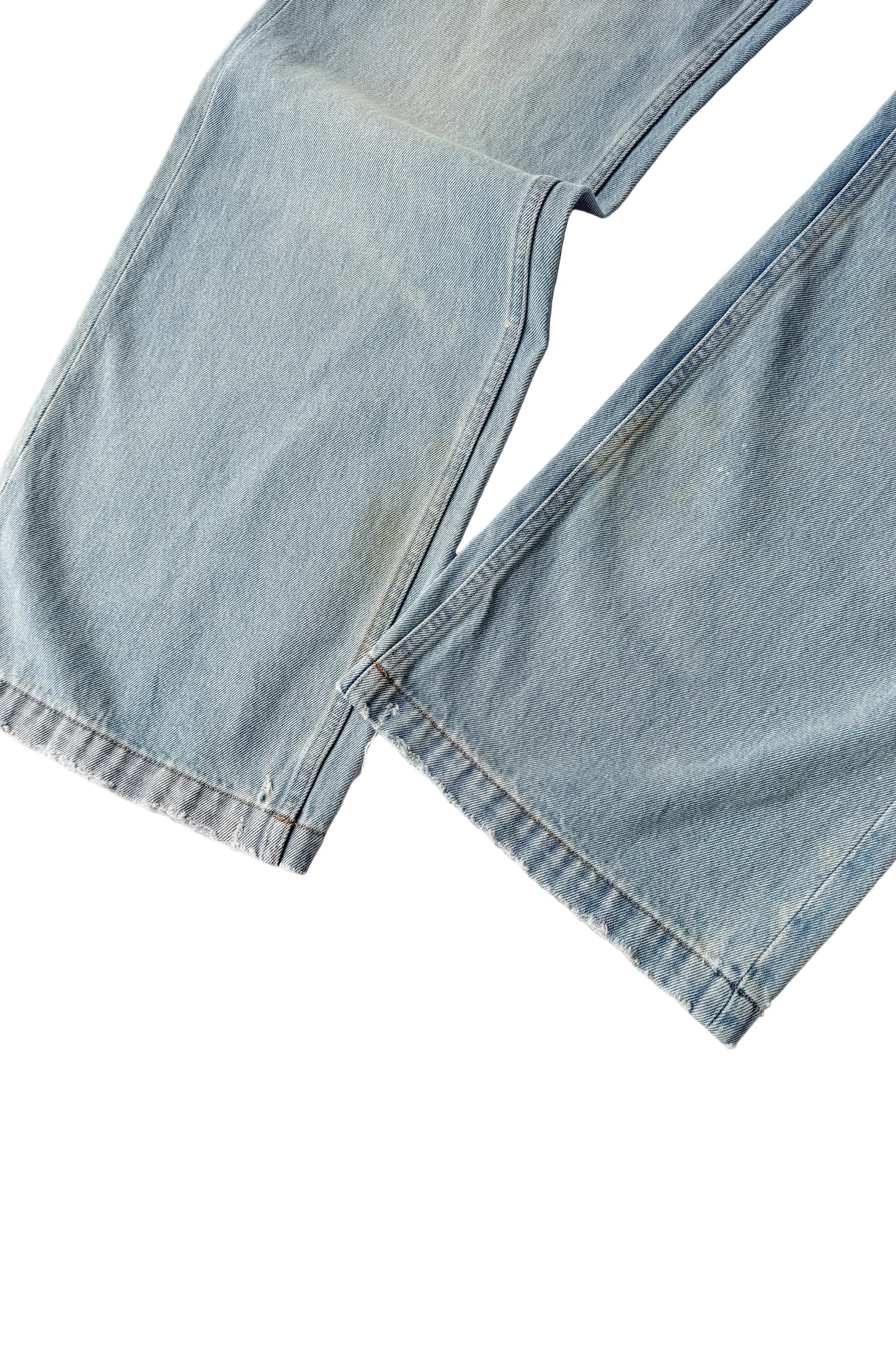 Close-up of a light blue denim jacket on a white background
